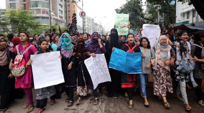 Students shout slogan during a rally as they join in a protest over recent traffic accidents that killed a boy and a girl, in Dhaka