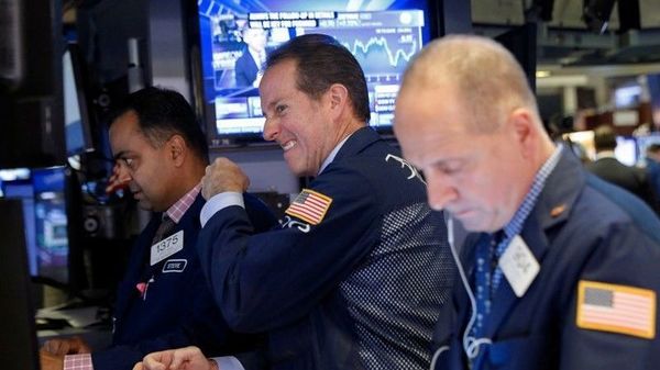 Traders work on the floor at the NYSE in New York